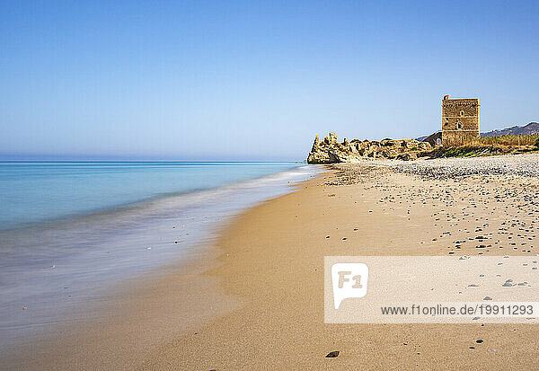 Italy  Sicily  Sandy beach with castle ruins in background