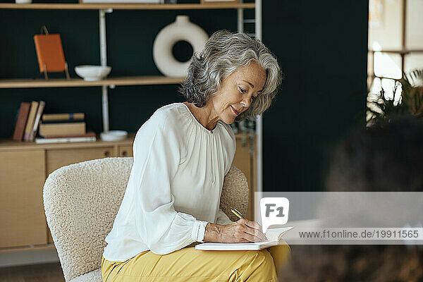 Psychotherapist writing details of counseling therapy in diary