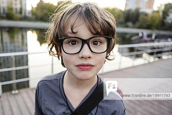 Cute boy wearing eyeglasses on bridge