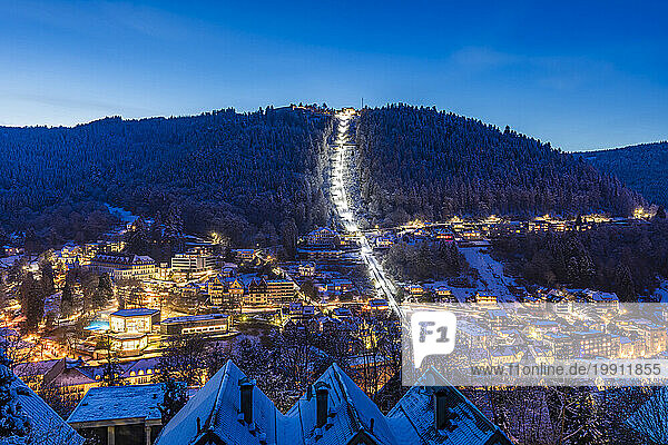Germany  Baden-Wurttemberg  Bad Wildbad  Illuminated town in Black Forest range at winter dusk