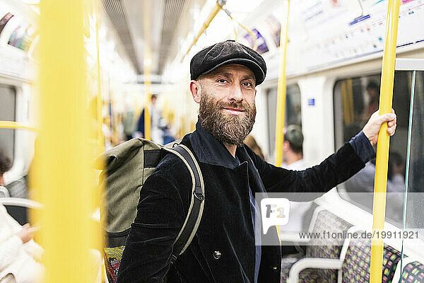 Smiling mature man traveling in train