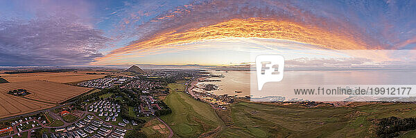 UK  Scotland  North Berwick  Aerial panorama of coastal town at sunset