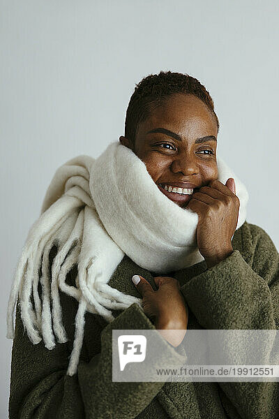 Smiling woman wearing scarf against white background