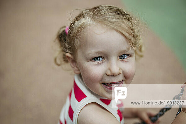 Portrait of little toddler girl having fun at playground