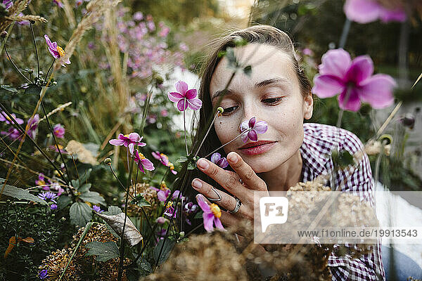 Woman smelling flowers at park