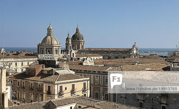 Italy  Sicily  Catania  Residential rooftops with church domes in background