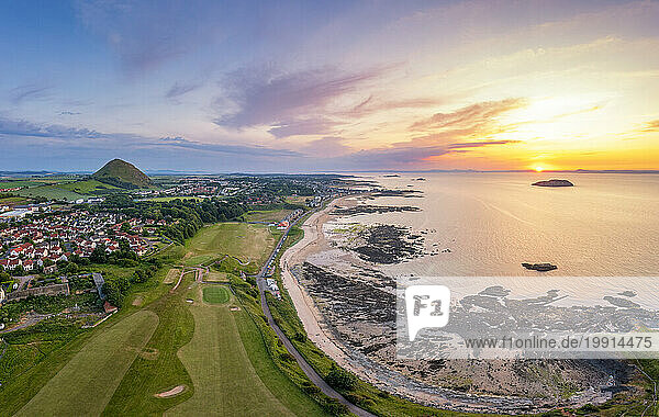 UK  Scotland  North Berwick  Aerial view of beach in front of coastal town at sunset