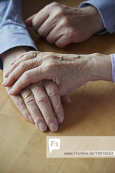 Close-up of senior couple holding hands
