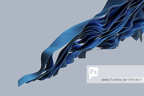 Wavy blue textiles flowing against gray background