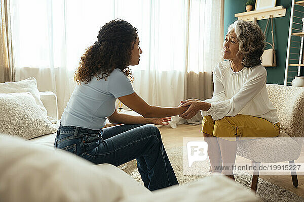 Psychologist consoling patient in therapy session at home