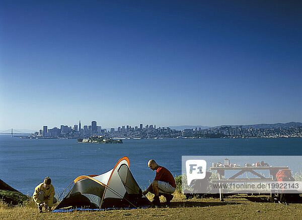 USA: California: Angel Island State Park: friends set up camp overlooking San Francisco and the Bay