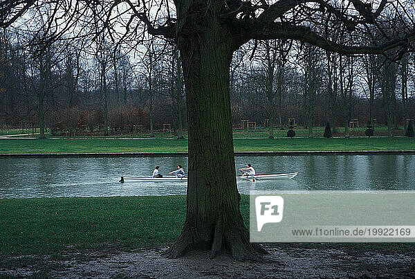 A team practices rowing in a lake on the grounds of the Palace of Versailles on the outskirts of Paris  France