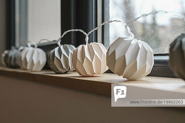White paper garland decorated on window sill
