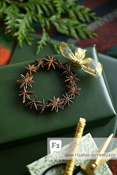 Wrapped presents and DIY Christmas decoration made of star anise