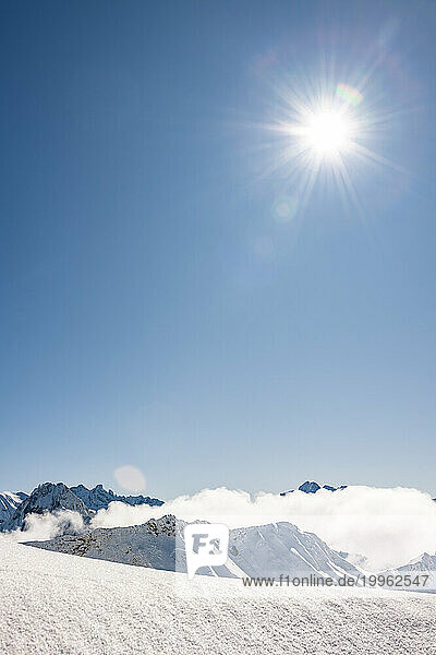 Germany  Bavaria  Sun shining over snowcapped Allgau Alps