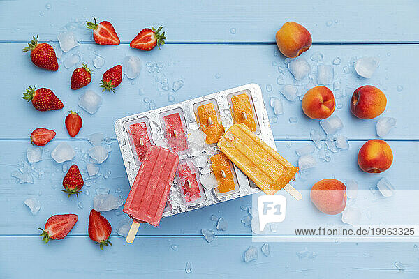 Studio shot of homemade strawberry and apricot flavored ice