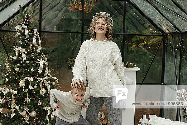 Happy mother and son enjoying Christmas at home