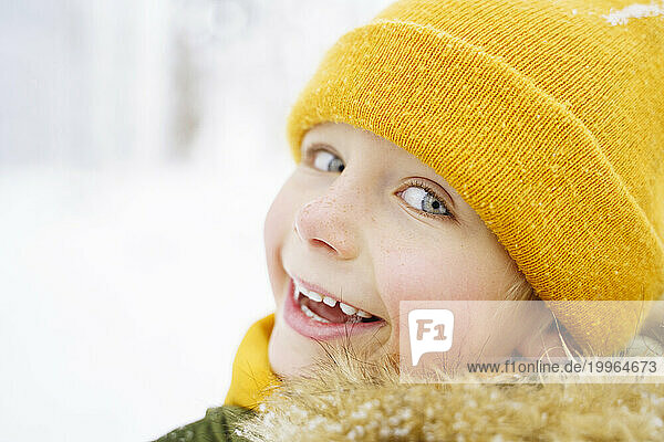 Happy boy wearing yellow knit hat