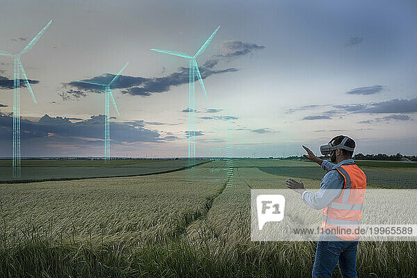 Engineer looking at digital wind turbine models in field