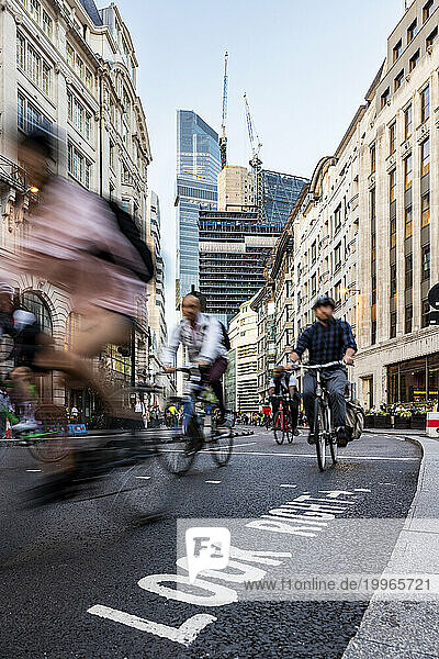 People cycling on road in city of London  UK