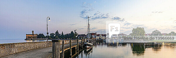 Germany  Baden-Wurttemberg  Langenargen  Edge of town on shore of lake Bodensee at dawn with pier in foreground