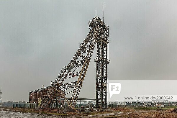 An old metal winding tower under a cloudy sky  a sign of the industrial past  Lost Place  Niederberg Colliery  Neukirchen-Vluyn  North Rhine-Westphalia  Germany  Europe