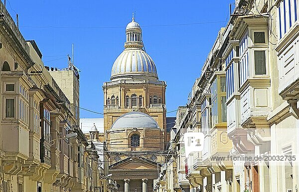Traditional houses with balconies dome of Paola parish church  Tarxien town  near Valletta  Malta  Europe