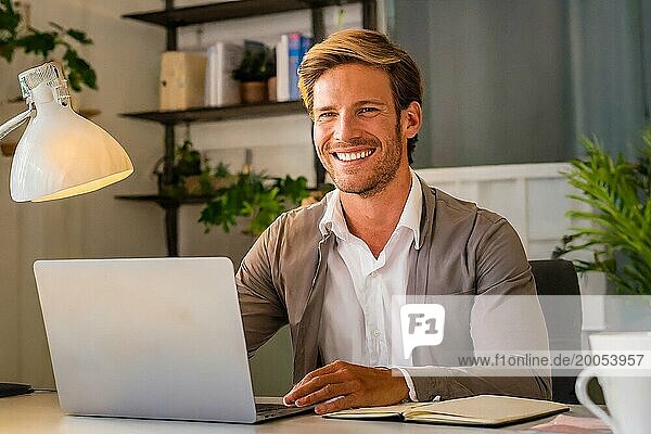 K generated  Successful young entrepreneur sits contentedly in the office  30  35  years  man  smiles contentedly  business founder  company boss