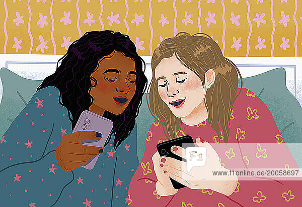 Teenage girl friends using smart phones and talking  enjoying sleepover