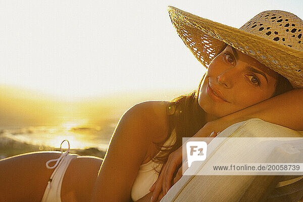 Woman Wearing Straw Hat Lying on Sun Lounger