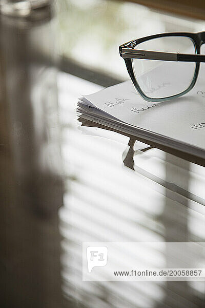 Eyeglasses and Paperwork on Desk