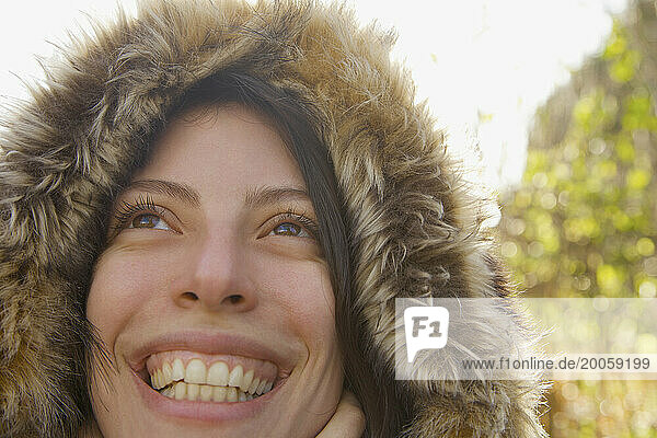Close up of a smiling woman wearing a hooded parka