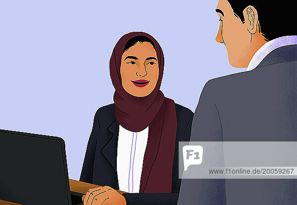 Businesswoman in hijab working at laptop  talking with businessman in meeting