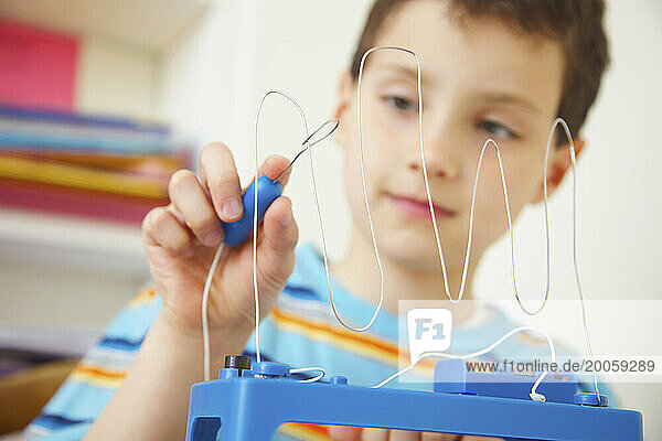 Boy Playing with Wire Coordination Game