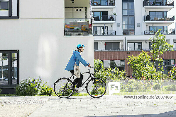 Young man biking in the city with helmet