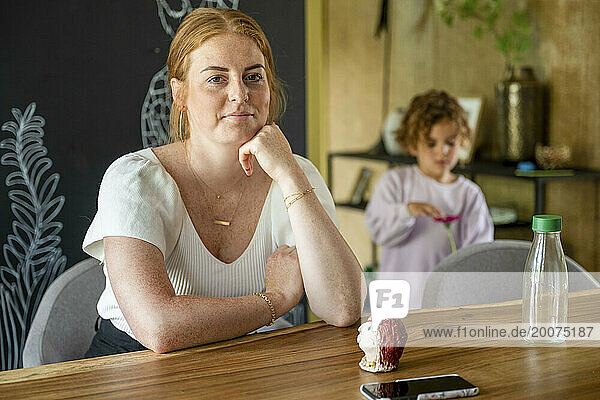 Portrait of a ginger beautiful woman sitting at her table