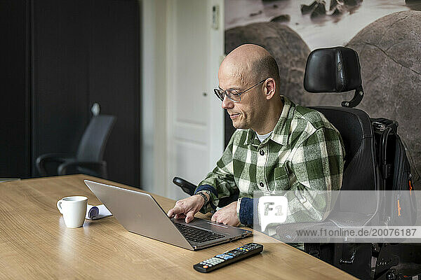 Disabled businessman working on his computer.