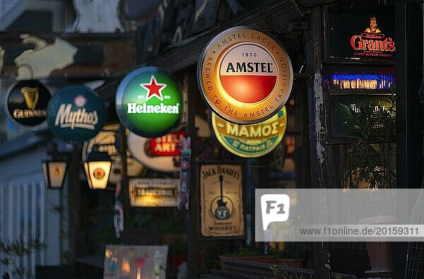 Illuminated advertising for beer brands  Logos  Amstel  Heineken  Mythos  Grants  Bar  Peraia  also Perea  Thessaloniki  Macedonia  Greece  Europe