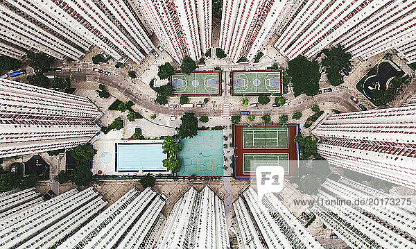 Sports courts with swimming pool near tall buildings in Hong Kong city