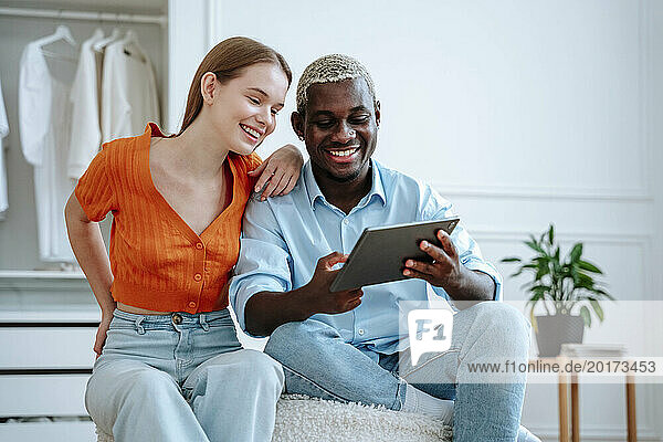 Happy young couple using tablet PC