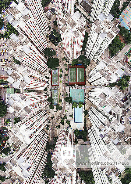 Swimming pool with sports courts near tall buildings in Hong Kong city