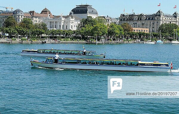 Switzerland: Two limmat river cruise boats crossing on lake Zürich in front of the Opera