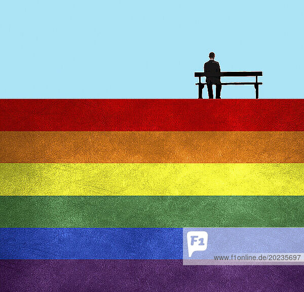 Mann sitzt auf einer Parkbank auf einer Regenbogenflagge