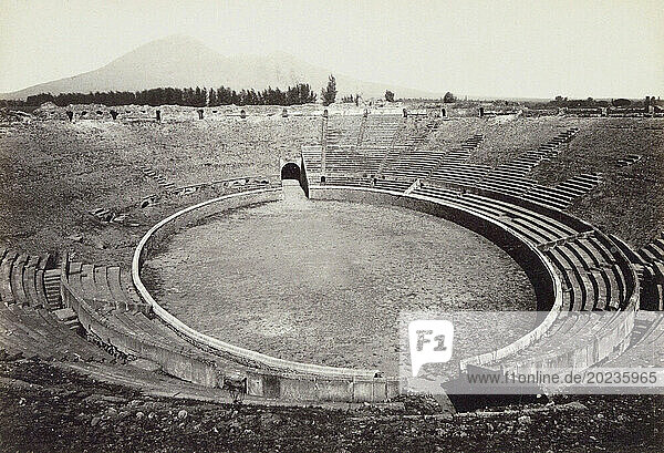 Pompeii Archaeological Site  Campania  Italy. The excavated Amphitheatre as it was in the late 19th century. Mt. Vesuvius  the volcano which destroyed the city can be seen in the background.