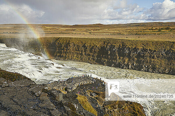 Tourists view Gullfoss waterfall in the Golden Circle of Southern Iceland; Iceland