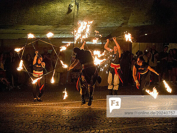 Fire jugglers and acrobats entertaining people at night  medieval reenactment; Grottazzolina  Fermo province  Marche  Italy