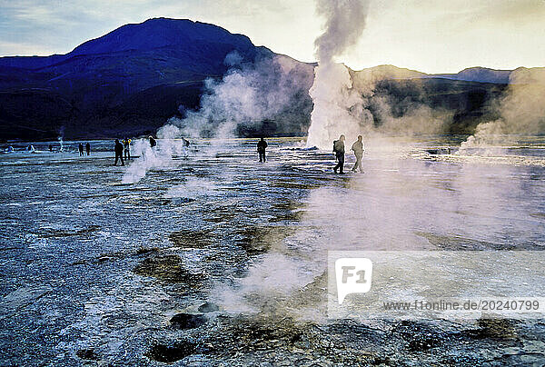Tourists are drawn to El Tatio  a geothermal field with geysers north of San Pedro at 4300 meters above sea level located in the Andes Mountains in the Atacama Desert. More than 70 geysers and fumaroles spew hot water and steam as the sun rises in Chile near the Bolivian border; Chile