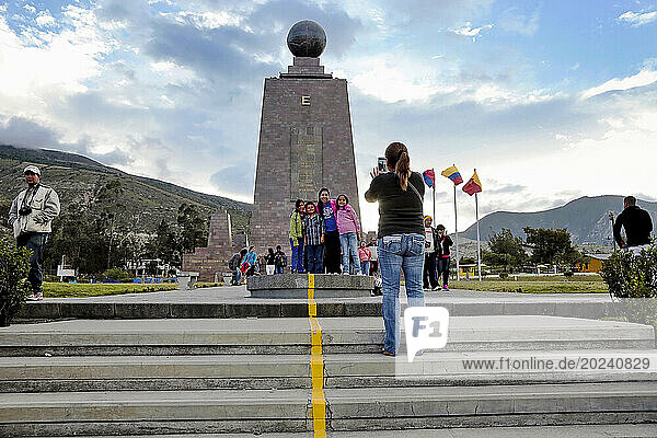 Tourists take pictures at Ciudad Mitad del Mundo  a monument to the Equator in Quito  Ecuador. The center line is painted on what is said to be the equator but the survey was later discovered to have been a few hundred meters in the wrong location. That doesn't stop tourists from enjoying the sites; Quito  Ecuador