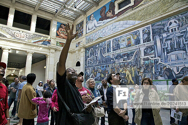 Tourists admire the Detroit Industry Murals by Mexican artist Diego Rivera; Detroit  Michigan  United States of America