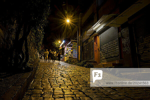 Pedestrians on a cobblestone street in Karakoy  Istanbul at night; Istanbul  Turkey